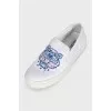 White slip-ons with branded embroidery