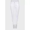 Tapered jeans with zippers at the bottom