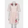 Beige dress decorated with embroidery
