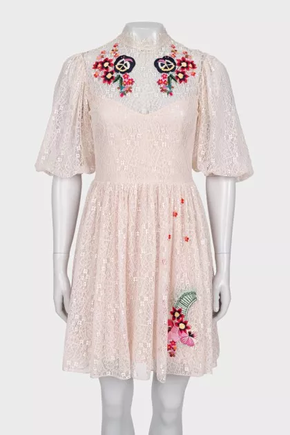 Beige dress decorated with embroidery