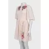Beige dress decorated with embroidery