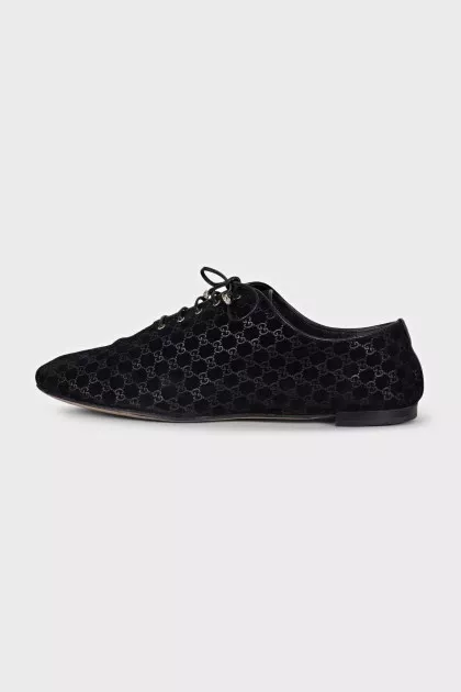 Black suede shoes with branded embossing