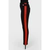 Pants fitting with red stripes with tag