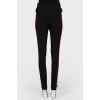 Pants fitting with red stripes with tag