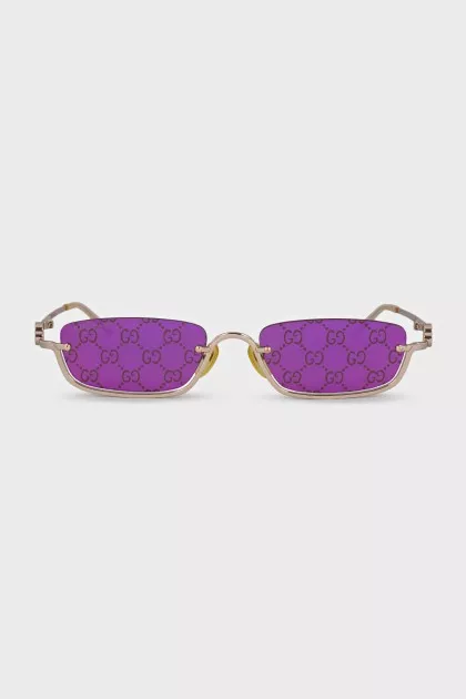 Gold sunglasses with logo on the lens
