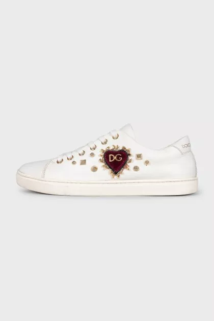White sneakers with rhinestones and a logo