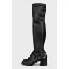 Black over-the-knee boots with leather tassels