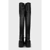 Black over-the-knee boots with leather tassels