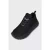 Black sneakers with a logo on a ribbed sole