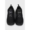 Black sneakers with a logo on a ribbed sole