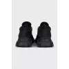 Black sneakers with a logo on a ribbed sole
