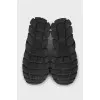 Black sneakers with a logo on a ribbed sole