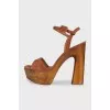 Suede sandals with a gold platform