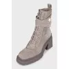 Gray lace-up boots with tag