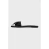 Black leather flip flops with a bow