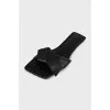 Black leather flip flops with a bow