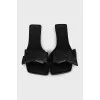 Black leather flip flops with a bow