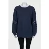 Sweatshirt with perforated sleeves