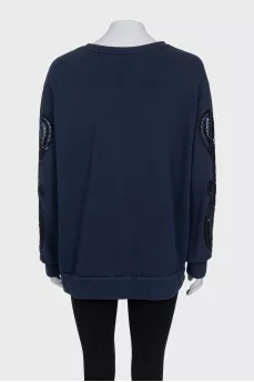 Sweatshirt with perforated sleeves