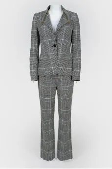 Costume jacket and trousers in a cage with a tag
