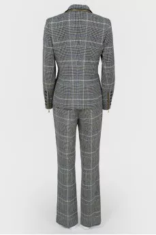 Costume jacket and trousers in a cage with a tag