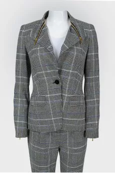 Costume jacket and trousers in a cage with a tag