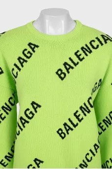 Green oversized jumper with a signature monogram
