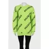 Green oversized jumper with a signature monogram