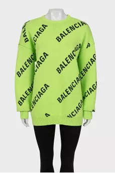 Green oversized jumper with a signature monogram