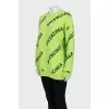 Green oversized jumper with a signature monogram