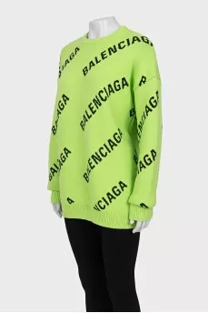Green oversized jumper with a signature monogram