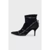 Suede ankle boots decorated with straps