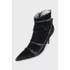 Suede ankle boots decorated with straps