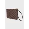 Clutch bag with a signature print and handle