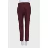 Burgundy trousers with creases