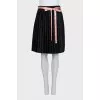 Black skirt with a pink belt