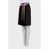 Black skirt with a pink belt