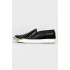 Black slip-ons with gold accents