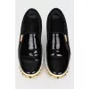 Black slip-ons with gold accents