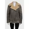 Straight sheepskin coat with a belt and zippers on the sleeves