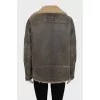 Straight sheepskin coat with a belt and zippers on the sleeves