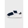 Leather sneakers decorated with blue fur