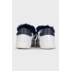 Leather sneakers decorated with blue fur
