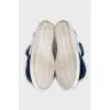 Leather sneakers decorated with blue fur