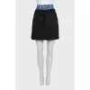 Black skirt with a jeans belt and tag