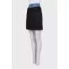 Black skirt with a jeans belt and tag