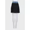 Black skirt with a jeans belt and tag