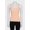 A tight orange tank top with a tag