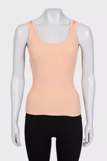 A tight orange tank top with a tag