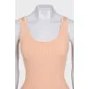 A tight orange tank top with a tag